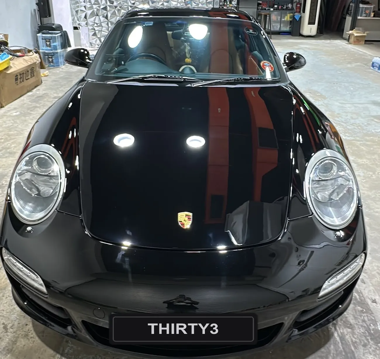 Porsche 911 with a machine-polished, mirror-finish bonnet at the detailing studio