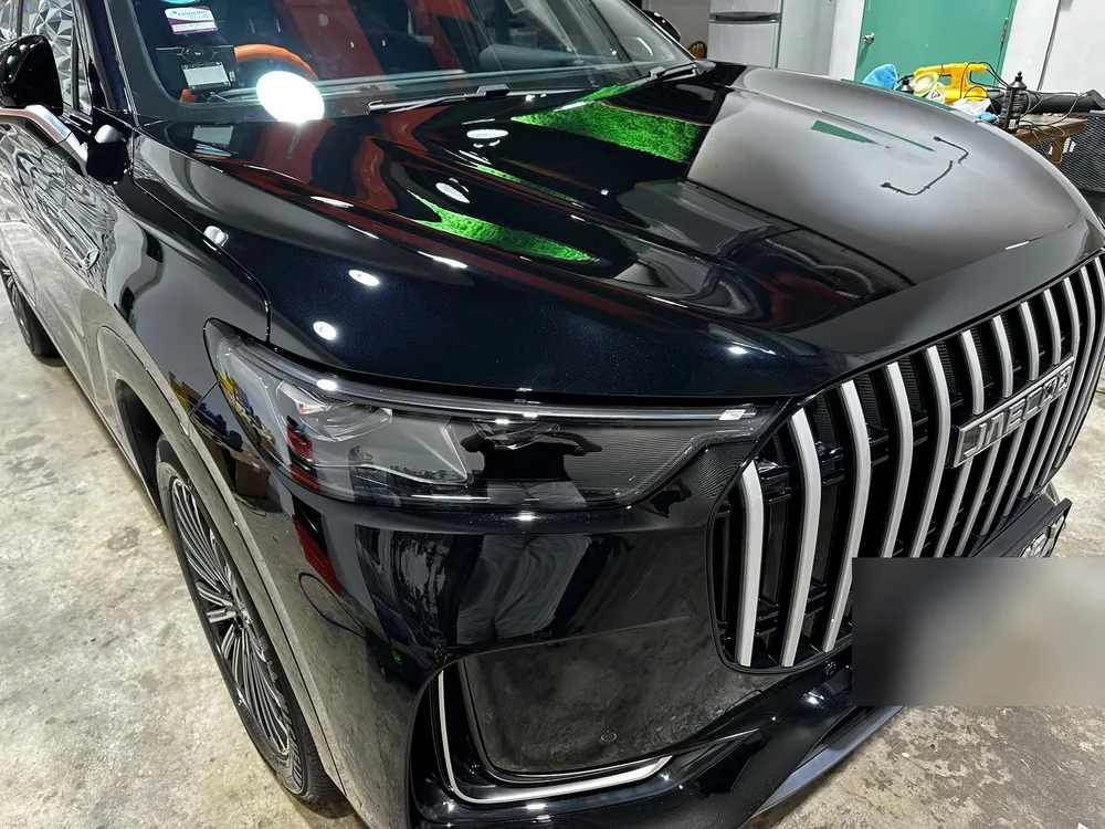 Black luxury SUV with a mirror finish after polishing