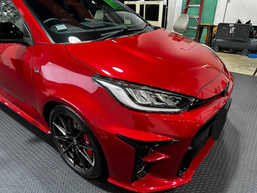Right front wing and headlight of the red GR Yaris