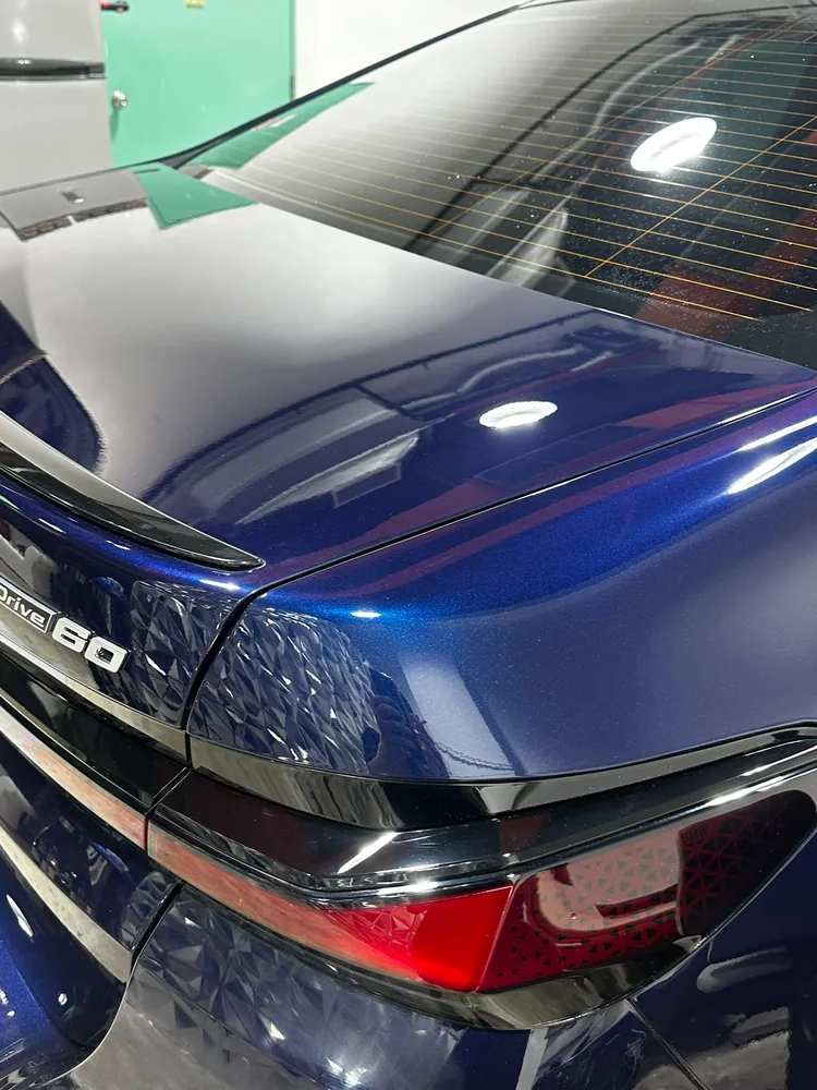 Close-up of a corrected blue BMW rear quarter